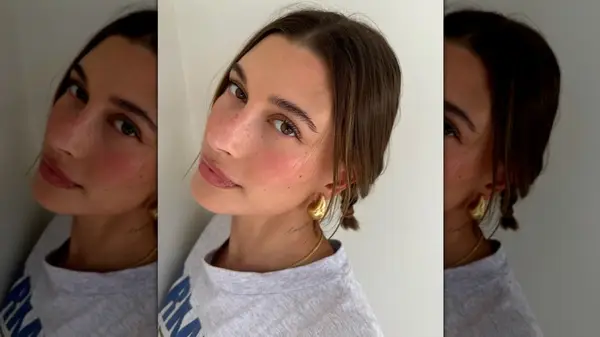 Hailey Bieber looking into the camera for a selfie with blush-stained cheeks
