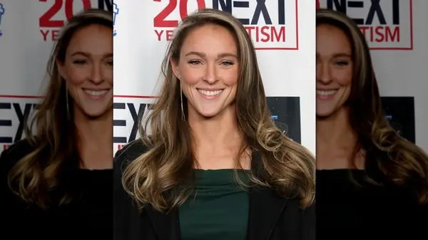 Kylie Kelce smiling at an event while wearing blush and mascara