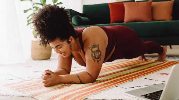 Tattooed person planking