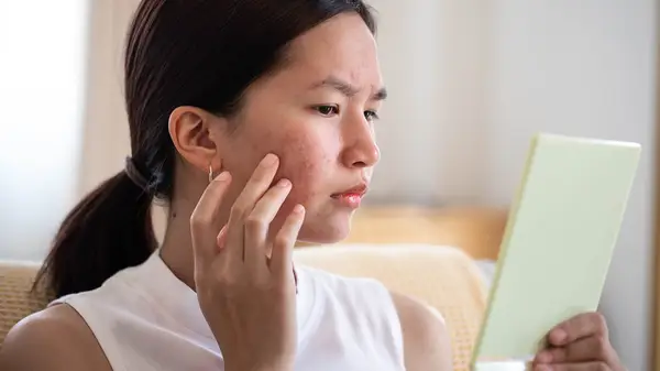 woman looking at her reflection