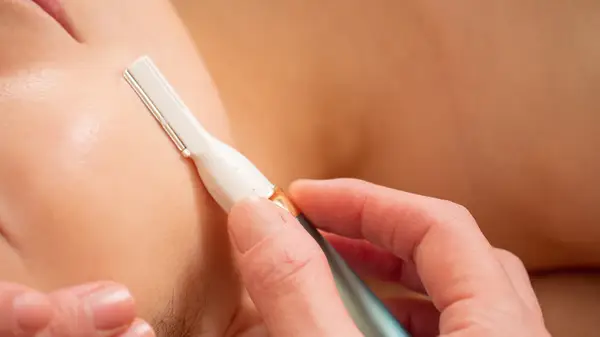 Dermaplaning the skin