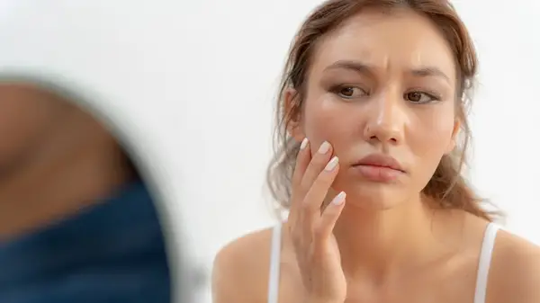 Woman looking at her skin