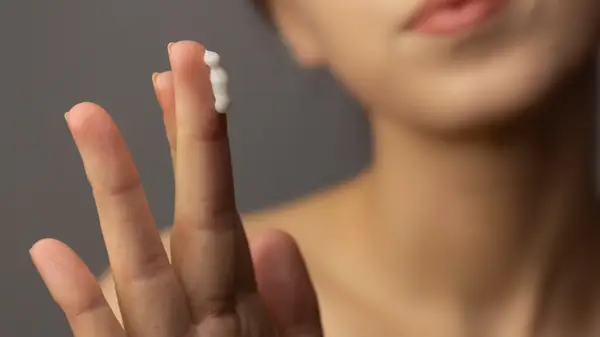 Woman cream on finger