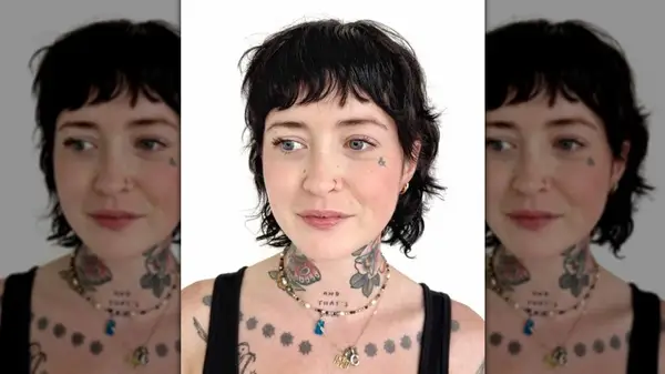 Woman with tattoos and dark shullet cut