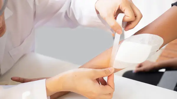 doctor dresses arm wound