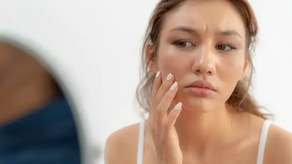 Woman looking at skin