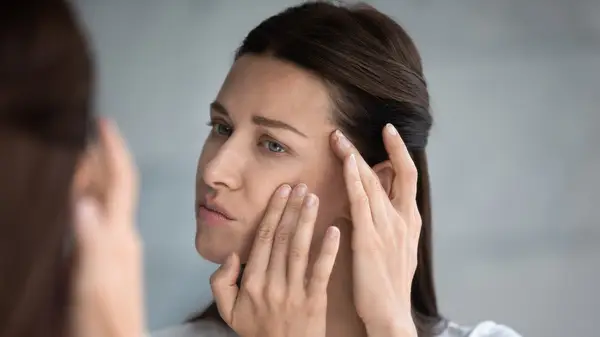 Woman looking in mirror