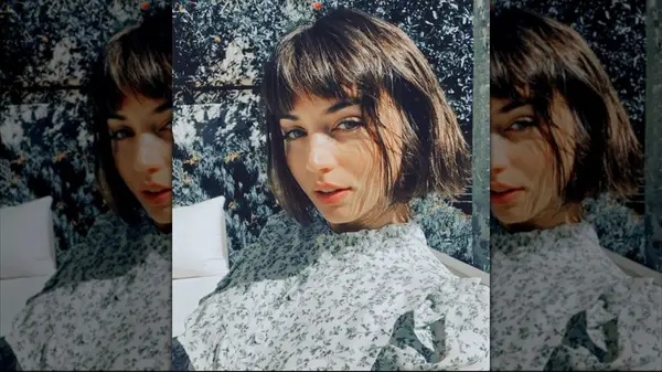 Ana de Armas posing for a selfie with a short, brown bob