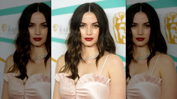 Ana de Armas posing at the EE BAFTA Film Awards 2023 with dark brown hair and subtle brown highlights