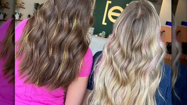 Two people with hair tinsel