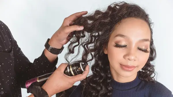 Woman having hairpspray applied