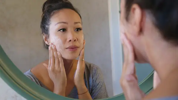 Woman applying skincare