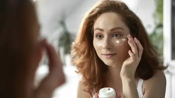 Woman applying skincare