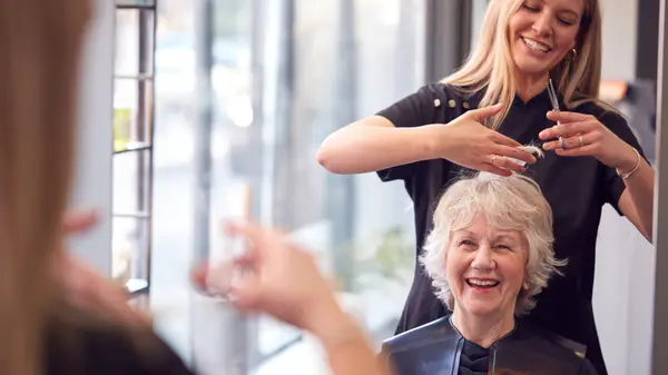 Older woman getting hair cut