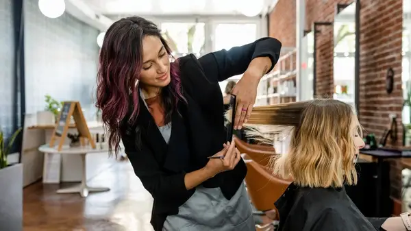 Hair stylist trimming hair