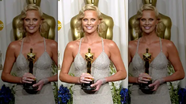 Charlize Theron posing with her Oscar at the 2004 Academy Awards