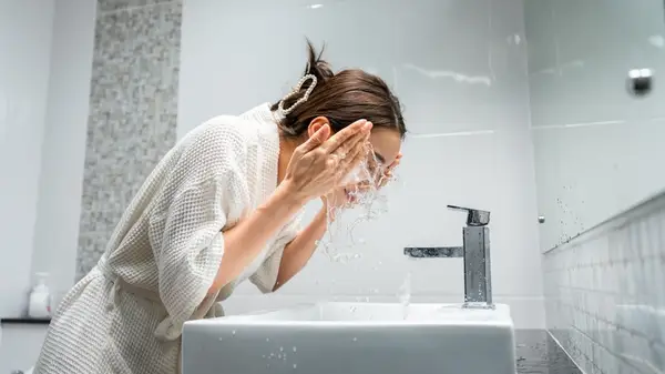 Woman washing her face