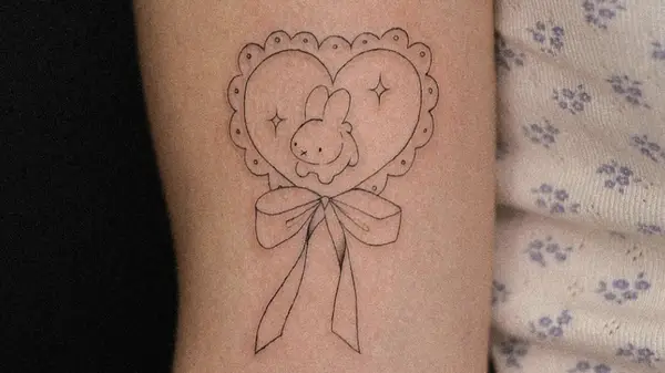 bunny and bow arm tattoo