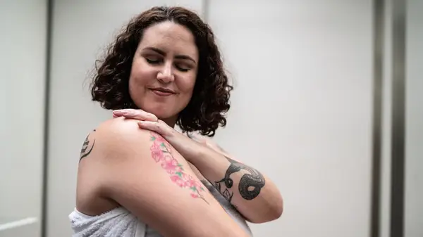 Woman with tattoos smiling