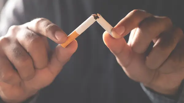 Hands snapping a cigarette