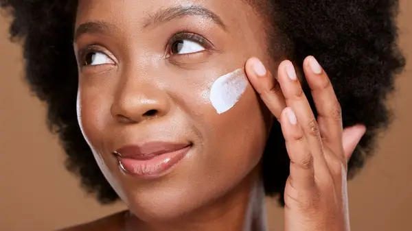 Woman applying sunscreen 