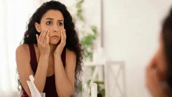 Woman looking at skin