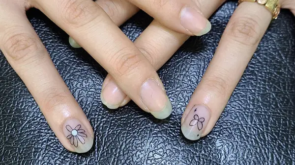 Small flower and butterfly with starburst fingernail tattoos