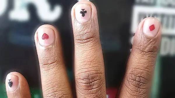 Fingernail tattoos of four card suits