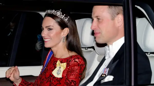 Kate Middleton with long, straight hair and a crown