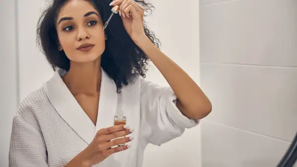 Woman applying skincare