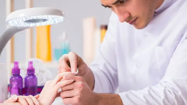Man cleaning client nails