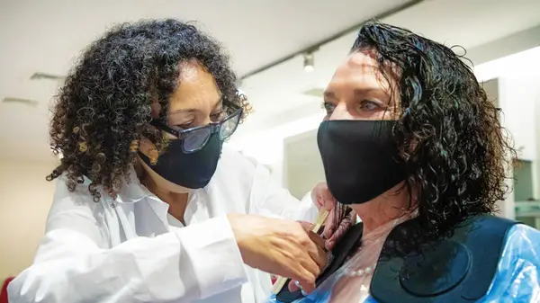 Stylist trimming client