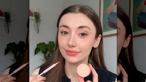 Woman applying lip tint
