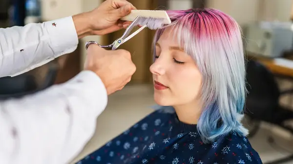 Woman getting a hair cut
