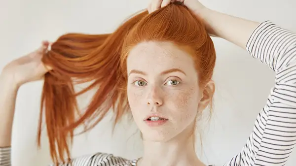 Woman touching her hair