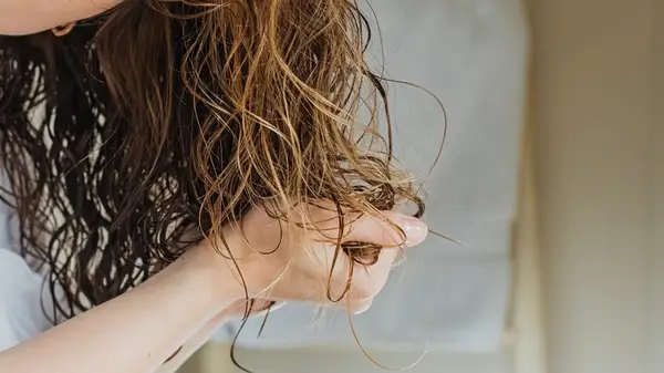 Woman scrunching her hair