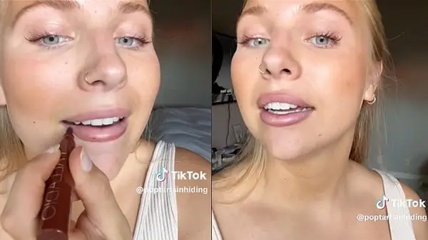 Woman demonstrating using lip stain as lip liner