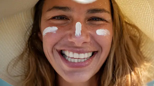 woman in hat and sunscreen