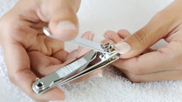 woman cutting her nails