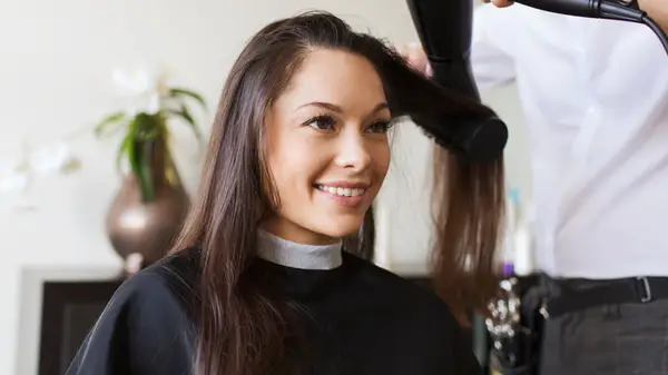 Woman having her hair blow-dried