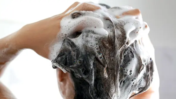 woman washing hair with shampoo