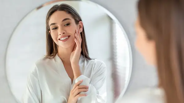 happy woman looking at skin