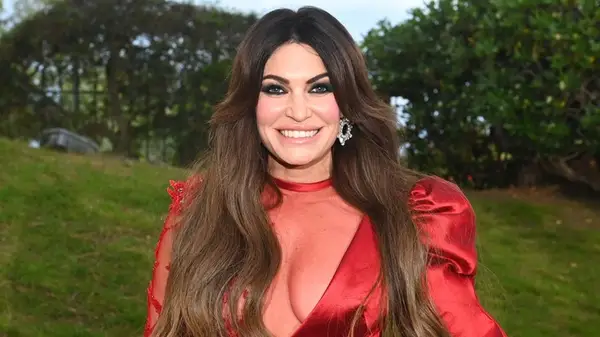 Kimberly Guilfoyle smiling in a red dress