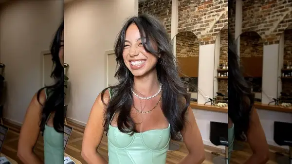 woman smiling in salon with butterfly cut