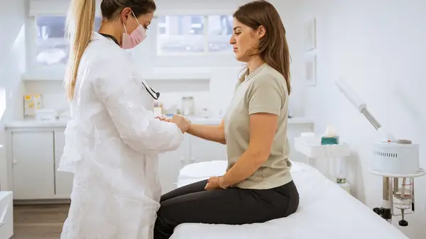 A doctor examines a woman
