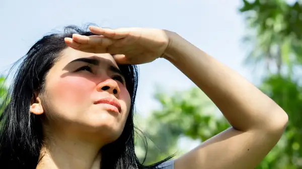 A woman looks at the sun