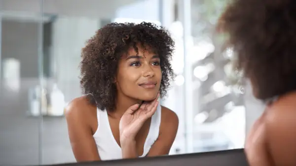 woman examining skin