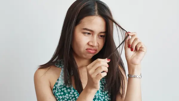 Woman looking at her hair