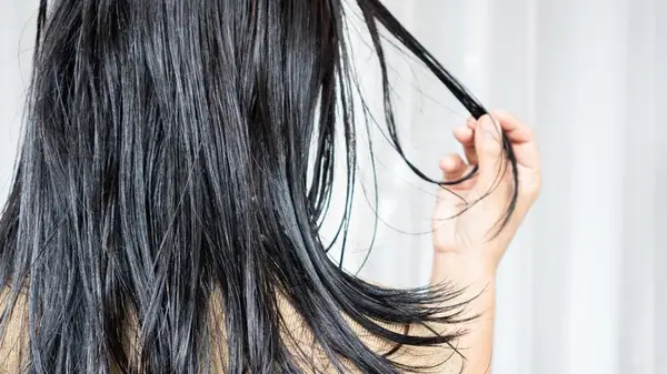 Woman looking at her hair