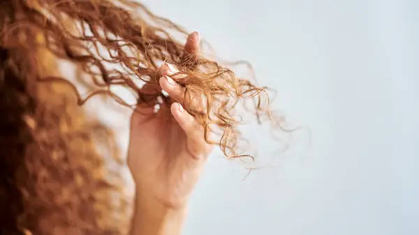 Woman touching dry hair